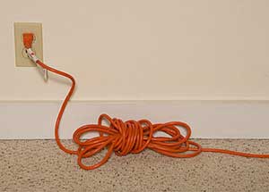 Extension cord plugged into electrical receptacle
